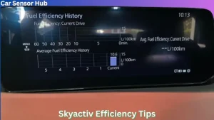 Mazda 3 hatchback driving on highway with fuel efficiency display