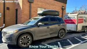 Mazda CX‑5 towing a camper trailer on a mountain road