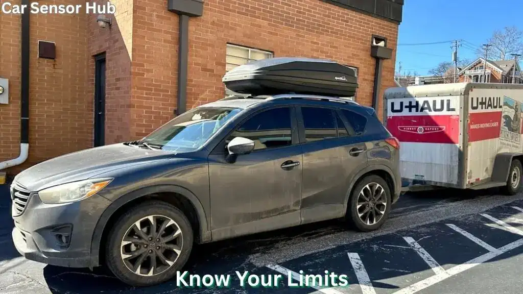 Mazda CX‑5 towing a camper trailer on a mountain road