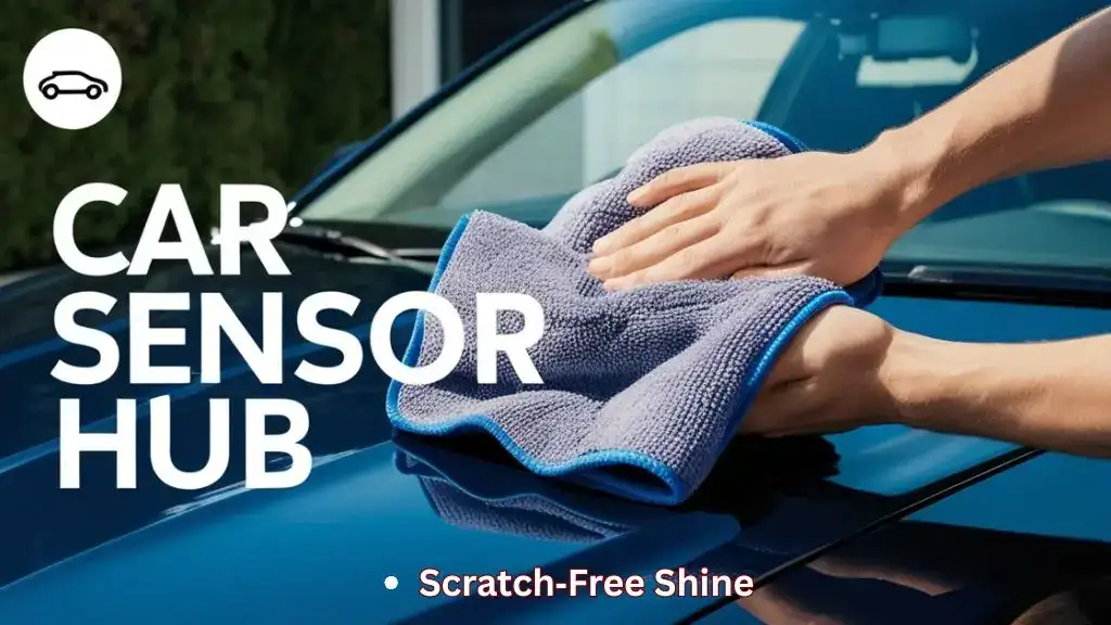 Person drying a car hood with a plush microfiber towel during detailing