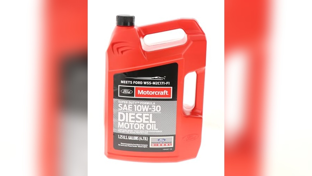 Pouring 0W-30 full synthetic motor oil into a Ford F-150 engine during freezing winter weather.