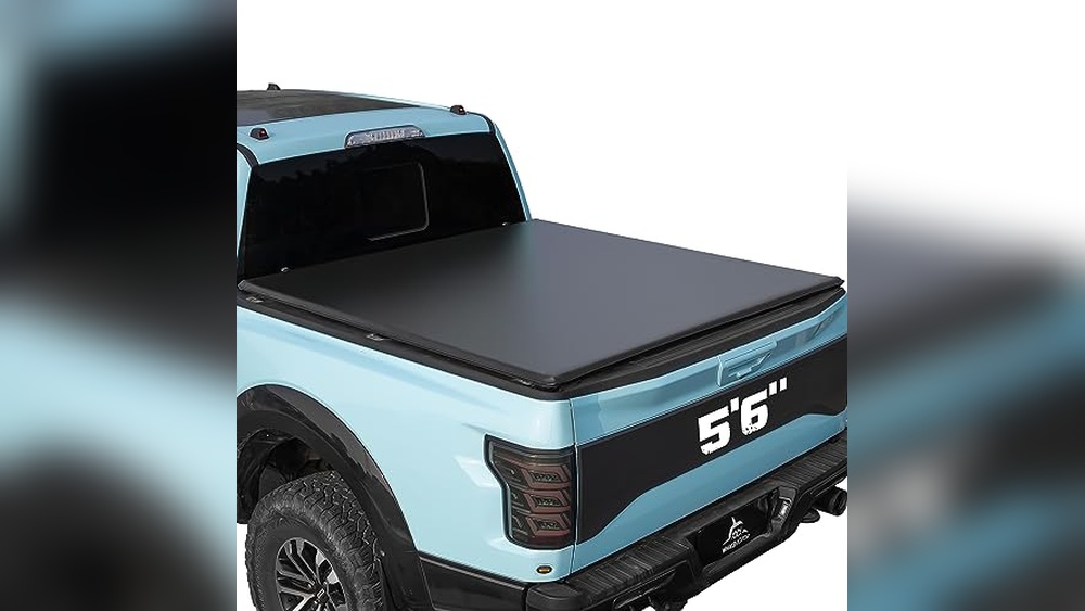 Ford F-150 winter tonneau cover protecting a truck bed from snow in a realistic winter environment
