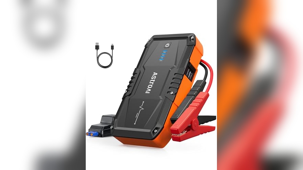 Best portable jump starter for Ford F-150 V8 in use with heavy-duty clamps starting a truck battery in an emergency roadside setting