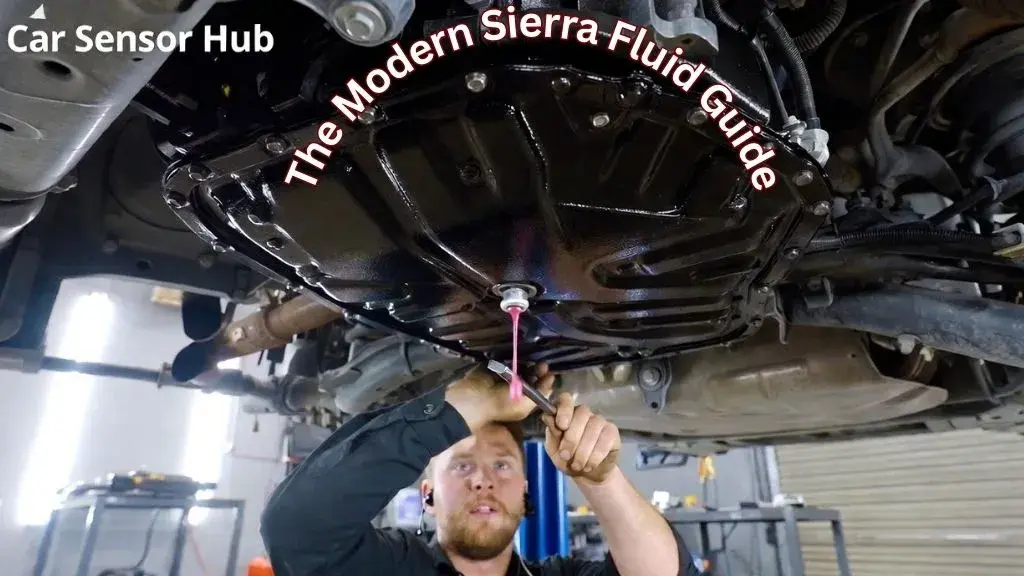 A technician checking the transmission fluid level at the check plug on a GMC Sierra 10-speed transmission.