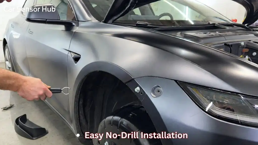 A person installing mud flaps on a Tesla Model 3 by removing the factory push clips from the wheel liner.