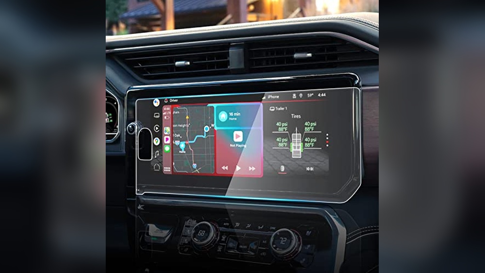 A matte anti-glare screen protector being installed on a 13.4-inch GMC Sierra 1500 infotainment system to prevent fingerprints and scratches.