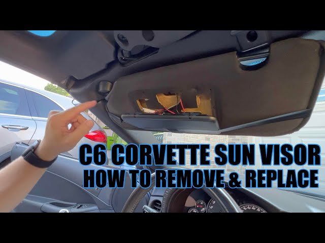 A silver C6 Corvette parked with a custom sun shade protecting the interior.