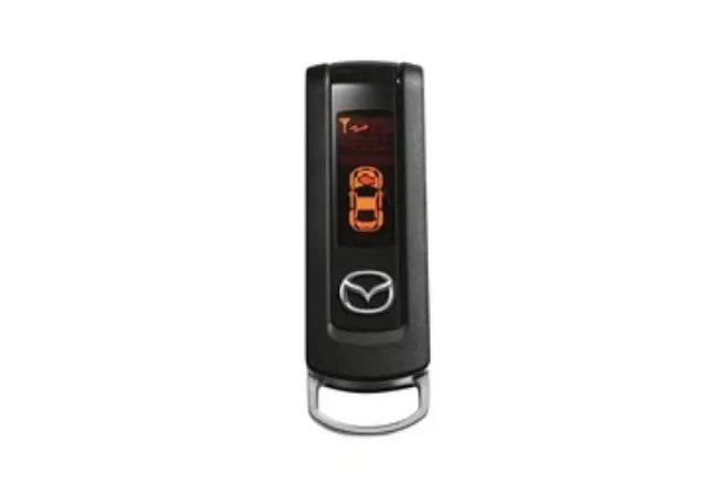 A modern Mazda key fob rests inside a vehicle highlighting remote start technology.