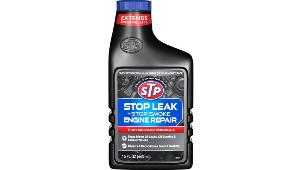 A mechanic pouring engine oil stop leak additive into a Ford Fusion engine.