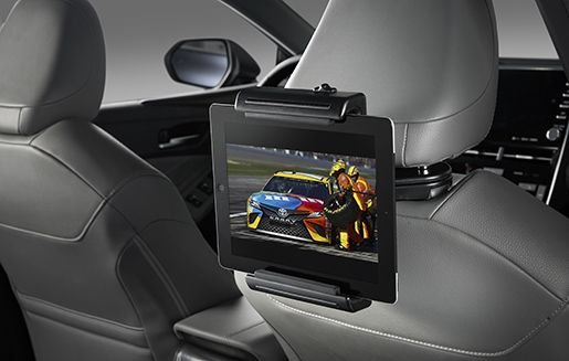 Backseat tablet holder mounted on a Toyota Corolla headrest holding a device.