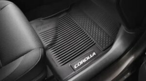 Black all-weather floor mats installed inside a Toyota Corolla vehicle interior.