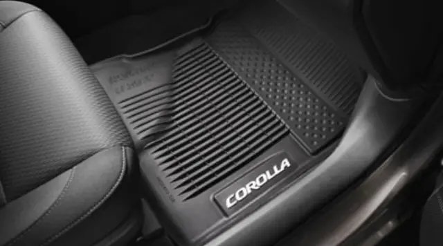 Black all-weather floor mats installed inside a Toyota Corolla vehicle interior.
