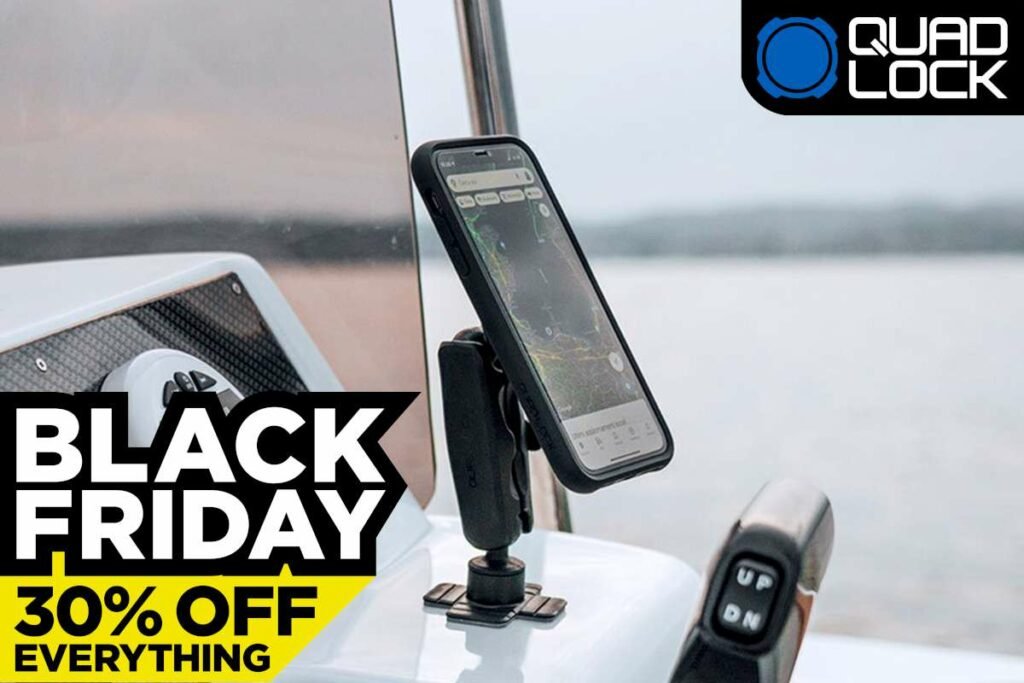 Black car phone mount on a windshield holding a smartphone in a parked car