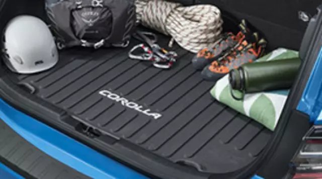 Black hatchback cargo liner fitted inside an open Toyota Corolla trunk.