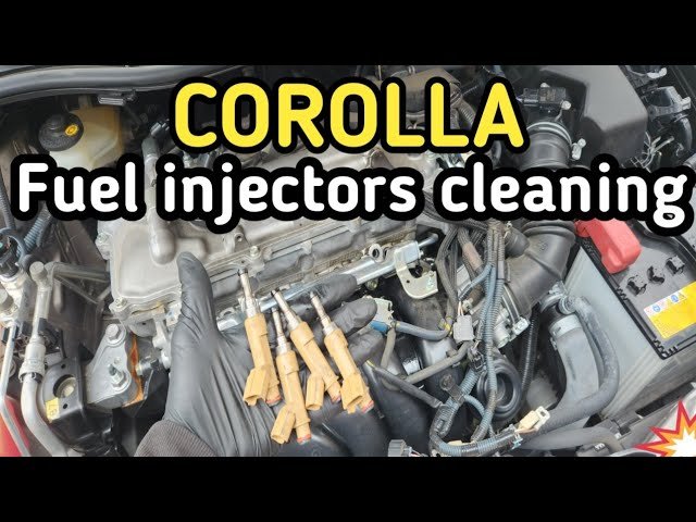Bottle of fuel system cleaner beside a silver Toyota Corolla's fuel filler