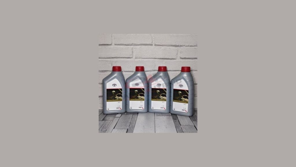 Bottle of Toyota ATF WS fluid on a garage workbench, ready for a Corolla Hybrid transmission service