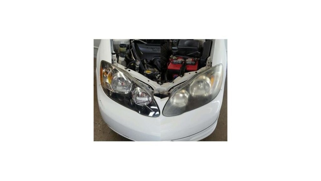 Cloudy Toyota Corolla headlight on workbench beside a restoration kit