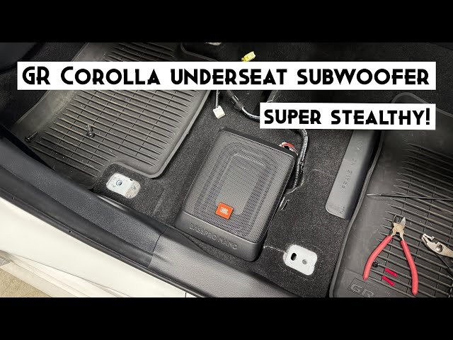 Compact powered subwoofer installed under the front seat of a Toyota Corolla