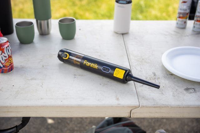 Handheld car vacuum on a car seat in daylight