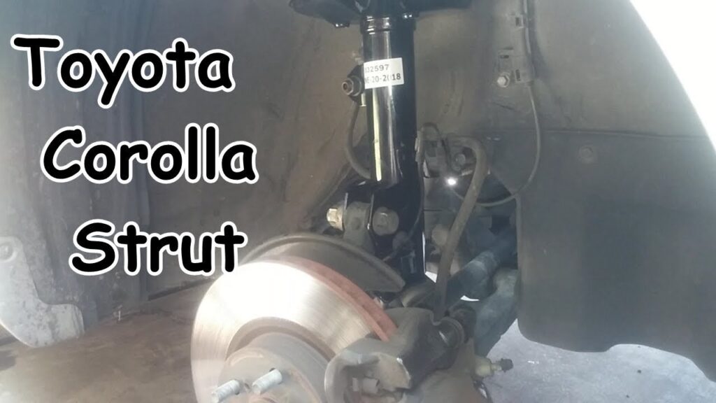 A high-quality front strut assembly for a Toyota Corolla on a clean workshop bench.