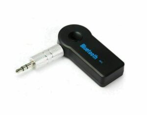 A modern car bluetooth adapter plugged into a vehicle dashboard for seamless audio streaming.