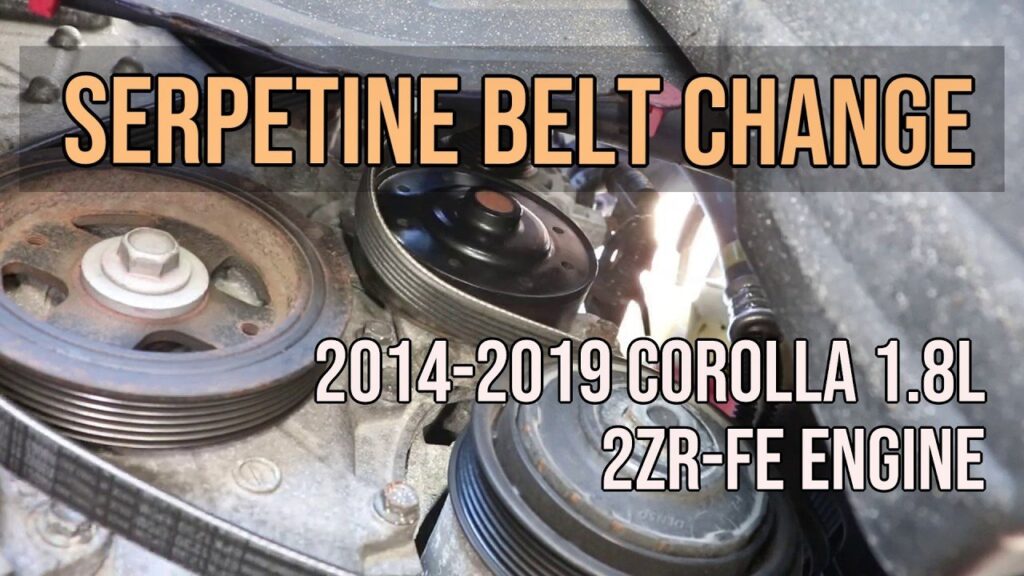 A new serpentine belt installed on a Toyota Corolla engine in a garage.