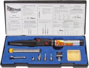 Open automotive soldering kit with iron, solder and heat-shrink tubing on a workbench