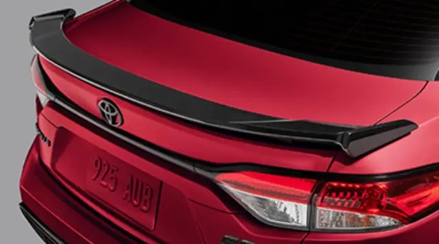 Rear spoiler on a silver Toyota Corolla parked on an urban street