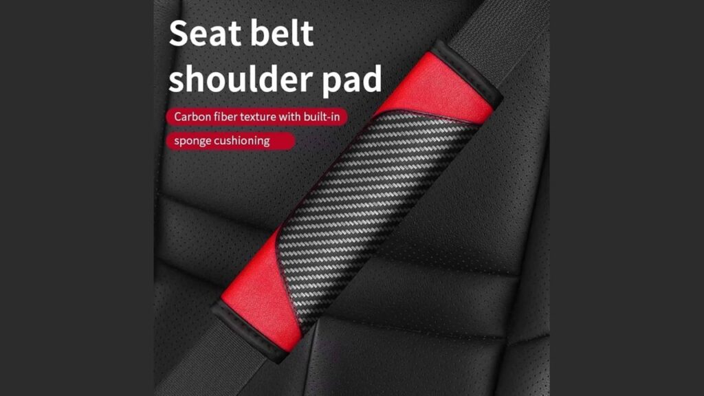 A soft charcoal seat belt pad shoulder cushion installed in a Toyota Corolla.