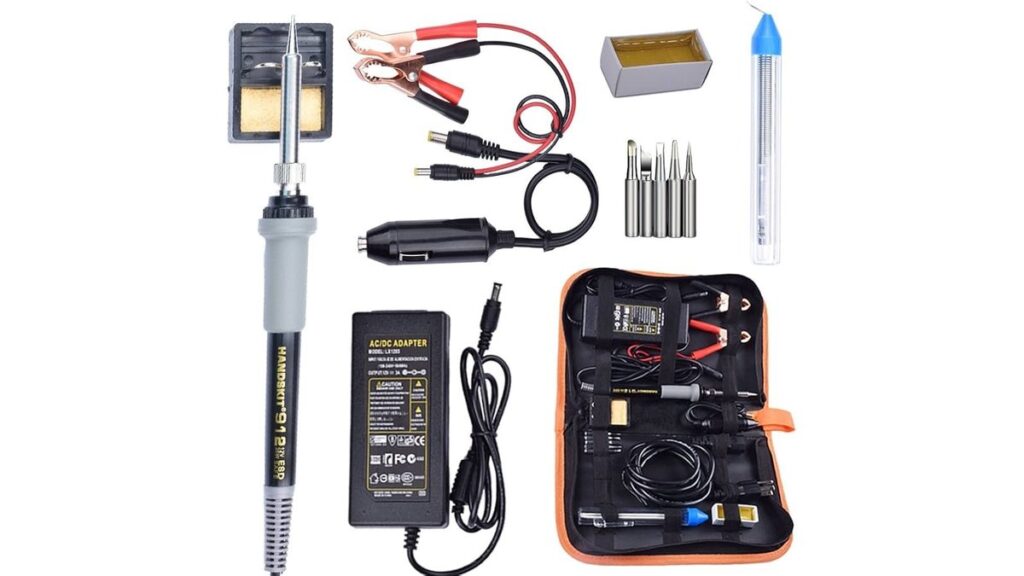 Soldering gun resting beside automotive wires on a garage workbench