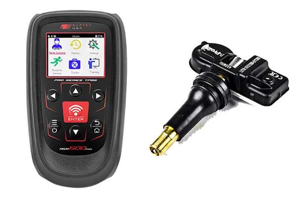 TPMS reset tool resting in a Toyota Corolla footwell in daylight