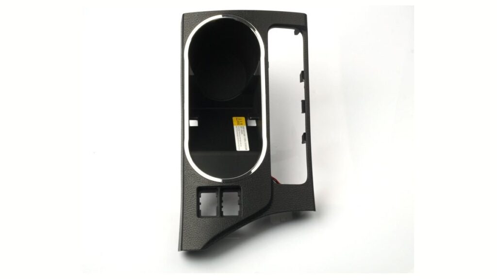 Wireless car charger installed in a Toyota Corolla console charging a phone.